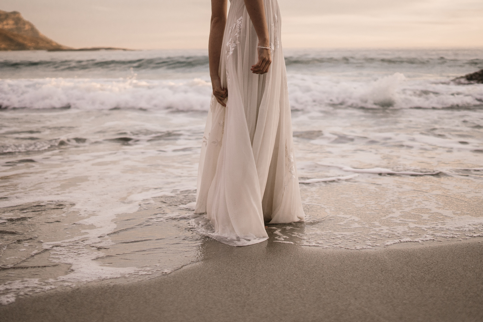 Woman in White Long Dress Standing on Beach