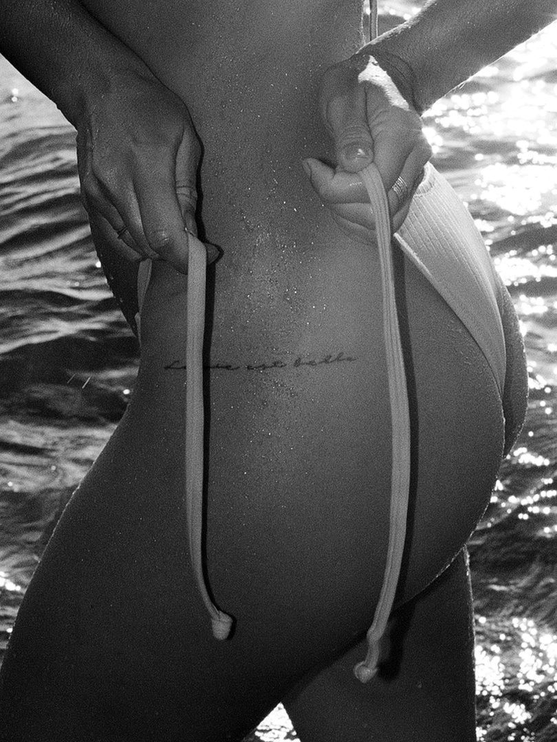 Woman Tying Her Bikini at the Beach
